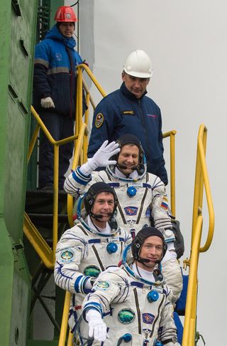 Roscosmos cosmonaut Andrey Borisenko (top) of Russia, NASA astronaut Shane Kimbrough (middle) and cosmonaut Sergey Ryzhikov climb the ladder to the elevator as they prepare to board the Soyuz MS-02 rocket for launch, Wednesday, Oct. 19, 2016 at the Baikonur Cosmodrome in Kazakhstan.