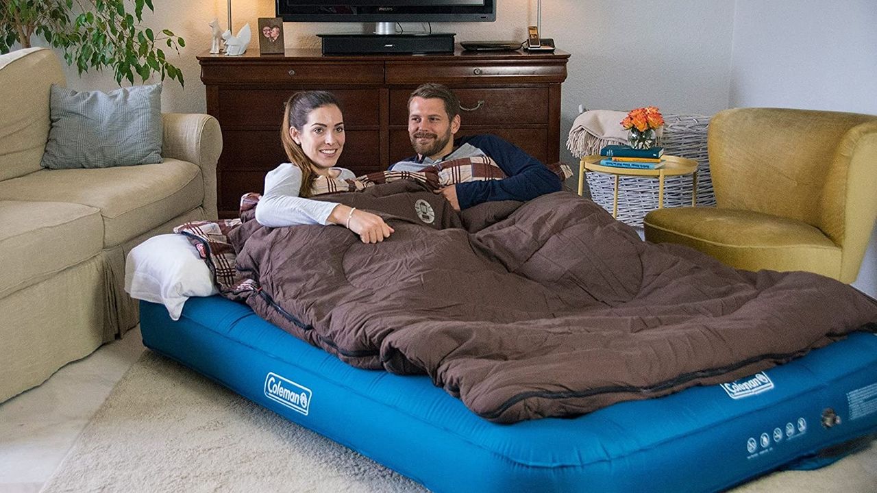 Couple lying on air mattress