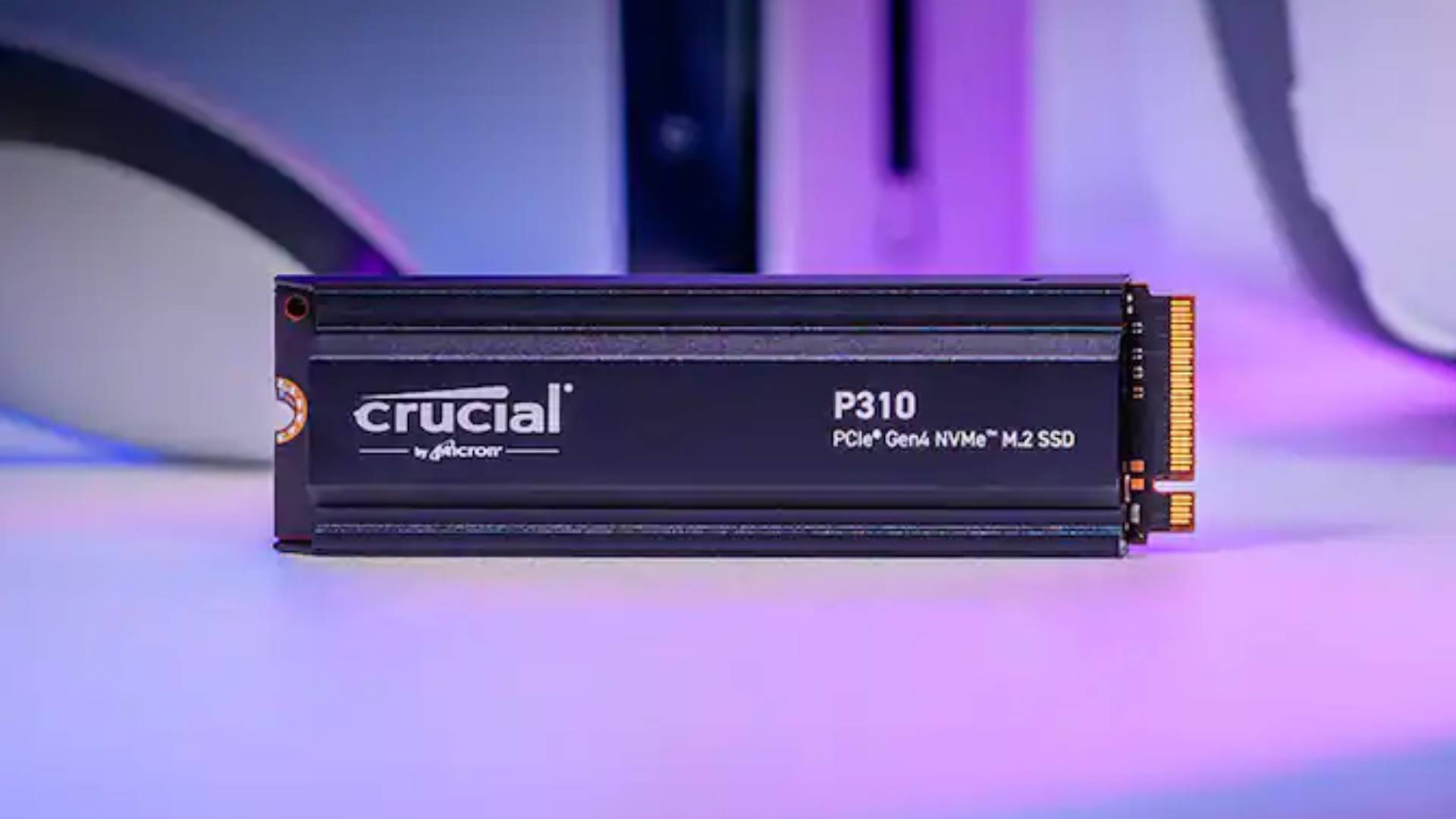 Official product image by Crucial featuring the P310 PS5 SD sitting on a white table with a purple background.