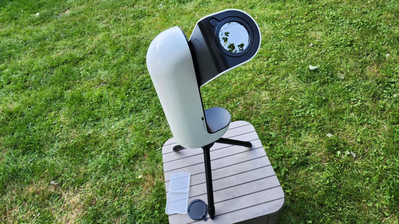The Vaonis Vespera Pro with solar filter pointing upwards with grass in the background.
