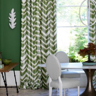 green dining room with chevron curtains