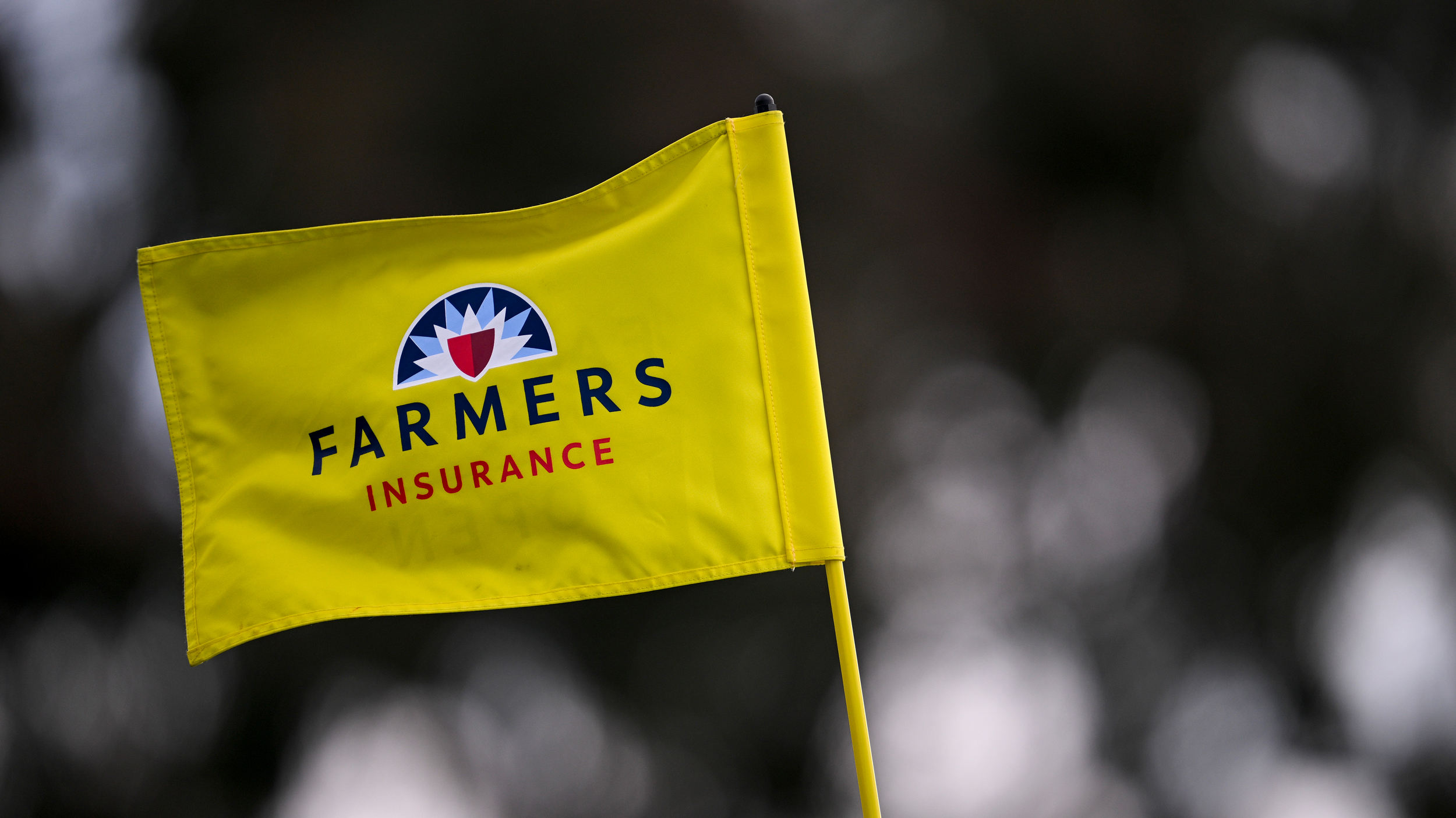 A general image of a yellow Farmers Insurance Open pin flag