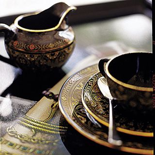 dining table with cup saucer and spoon