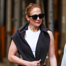 Jennifer Lopez wearing a white and black workout look with red sneakers in New York City July 2024