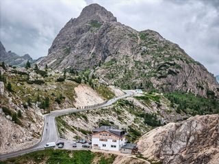 A cyclist descending a road in the Dolomites, Italy