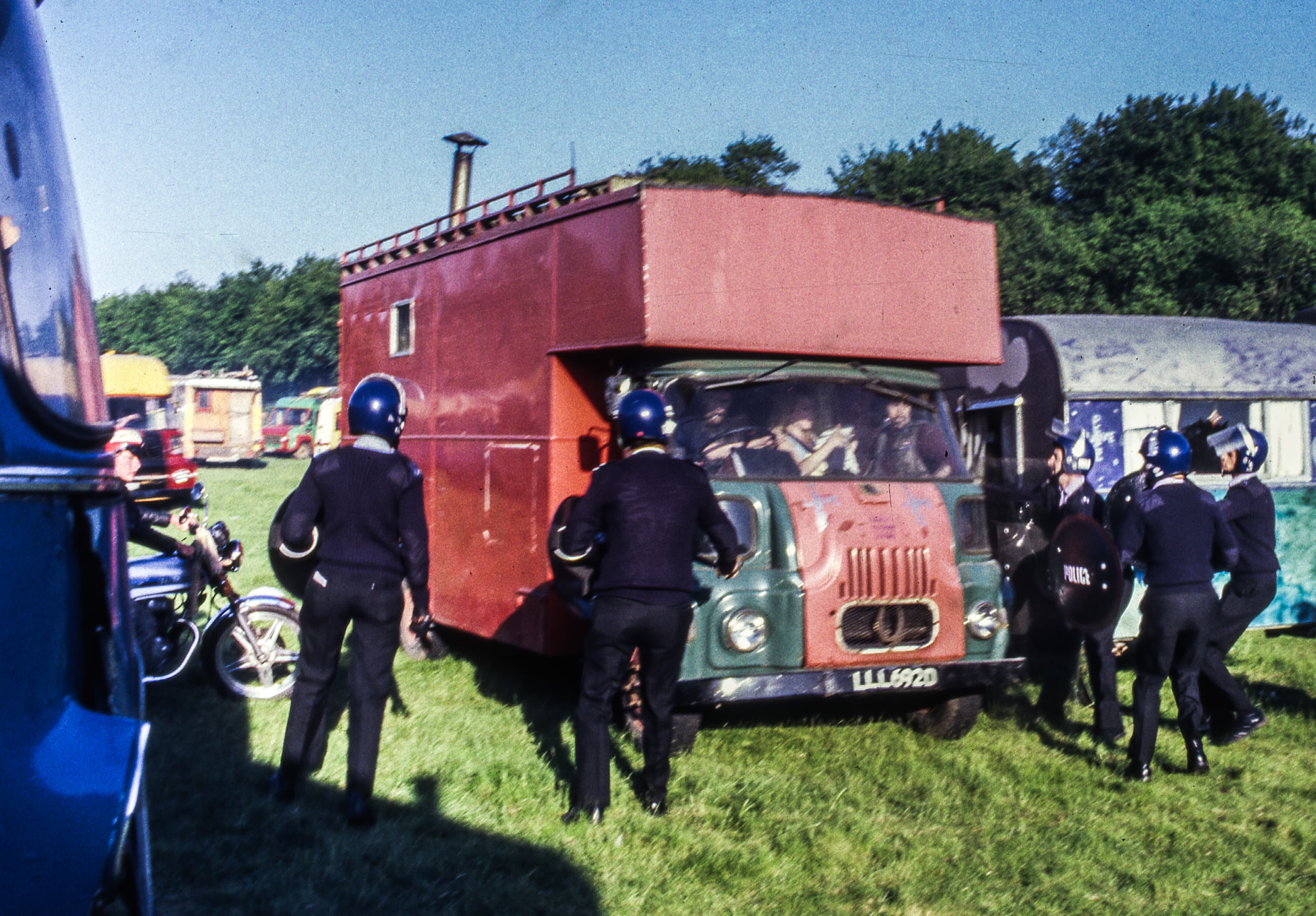 Police surround van with people inside.