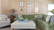 traditional living room with pistachio green corner sofa and peachy pink and white wallpaper