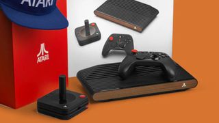 Atari VCS next to controller, joystick, box, and hat