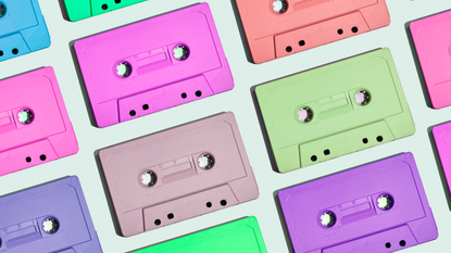 Directly above view of some multi colored audio cassette tapes on gray background.