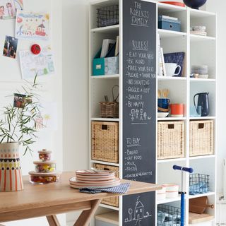 white room with shelf and wooden table