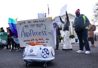 A delivery robot demonstrates the delivery of abortion pills by mail during the "Bans Off Our Mifepristone" action organized by the Woman's March outside of the Supreme Court on March 26, 2024 in Washington, DC.