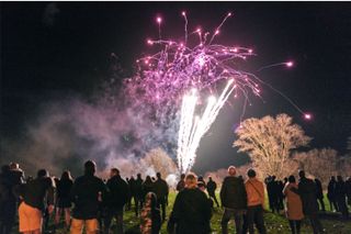 A crowd watching a fireworks display on Bonfire Night