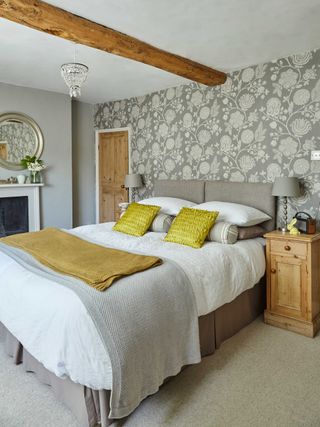 Double bed in grey bedroom with feature wall