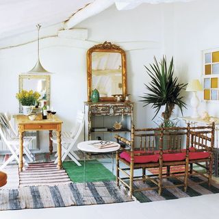 living room with mirror and potted plants