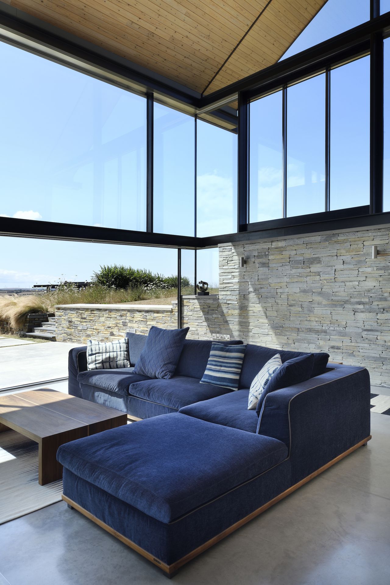 living room with stone wall and glazing