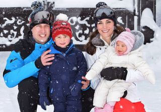 Prince William and Princess Kate kneeling in the snow with Prince George and baby Princess Charlotte on a ski vacation in 2016