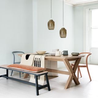dining area with white walls and wooden table with chair