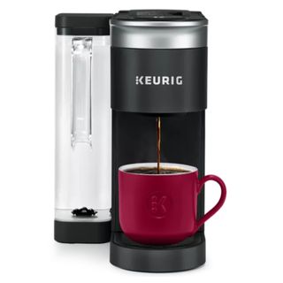 A Keurig K-Supreme SMART Coffee Maker making coffee into a red mug on a white background