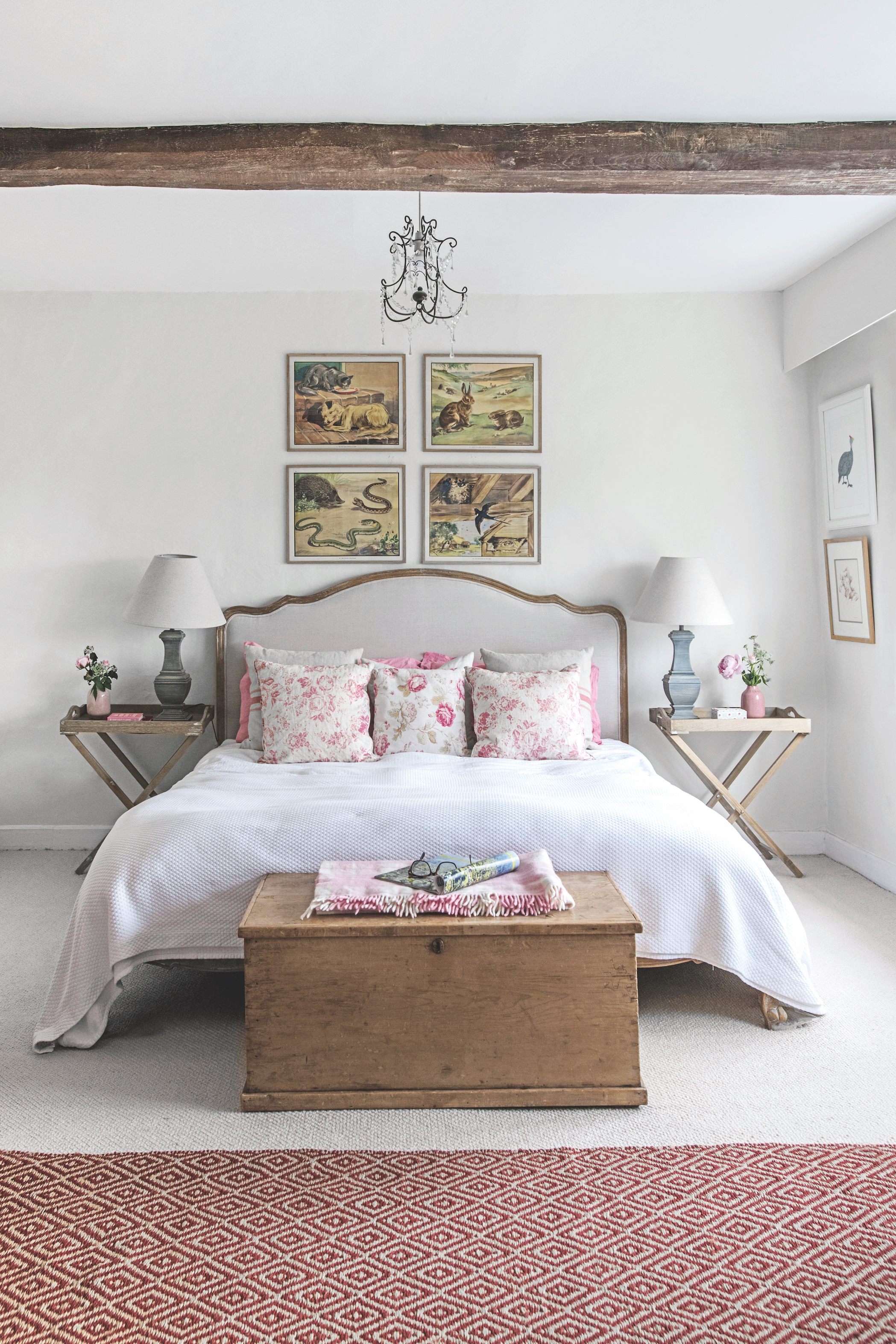 bedroom with double bed, art above headboard and ceiling with beam