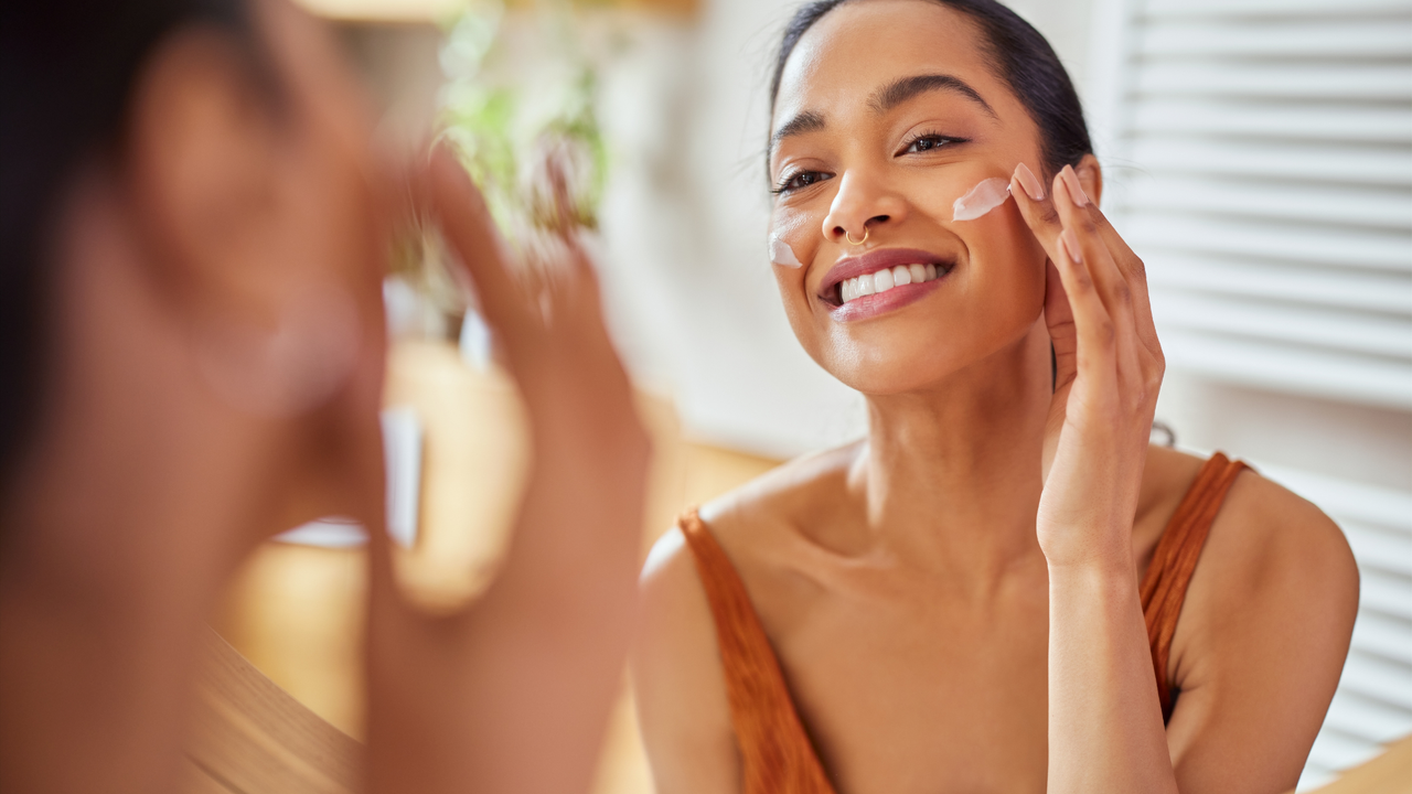 Woman using a moisturiser on her skin 