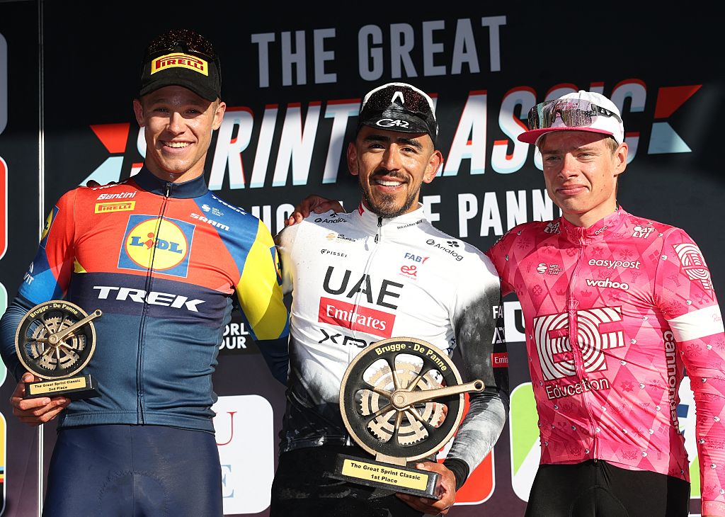 (LtoR) Italy's Jonathan Milan of Lidl-Trek (third place), Colombia's Juan Sebastian Molano of UAE Team Emirates (winner) and Estonian Madis Mihkels of EF Education-EasyPost (runner-up) pose during the podium ceremony of the 'Classic Brugge-De Panne' men's elite one-day cycling race, 195,6 km from Brugge to De Panne, Wednesday 26 March 2025. (Photo by KURT DESPLENTER / Belga / AFP) / Belgium OUT