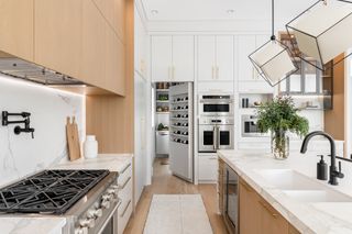 a bookshelf door with wine in a kitchen