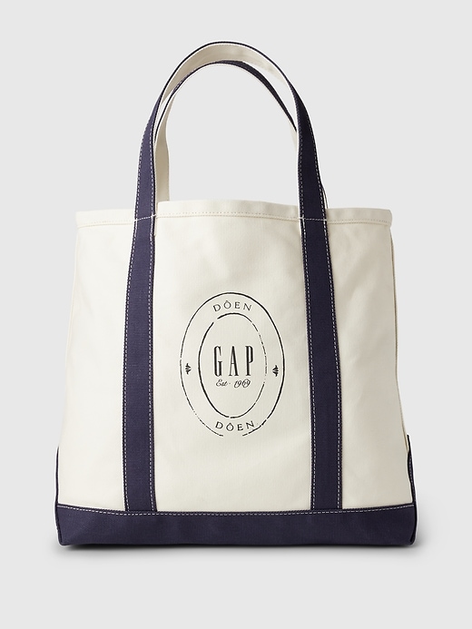 a white canvas tote bag with navy blue trim