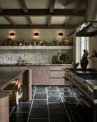 a kitchen with brown suede doors and decorative relief tiles with a wood grid ceiling