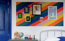 color blocking boys bedroom with a striped color block feature wall with art prints 