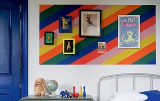 boys bedroom with a striped colour block feature wall with art prints