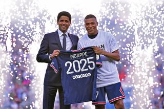 Kylian Mbappe poses with PSG President, Nasser Al-Khelaifi after extending his contract with the PSG prior to the Ligue 1 Uber Eats match between Paris Saint Germain and FC Metz at Parc des Princes on May 21, 2022 in Paris, France