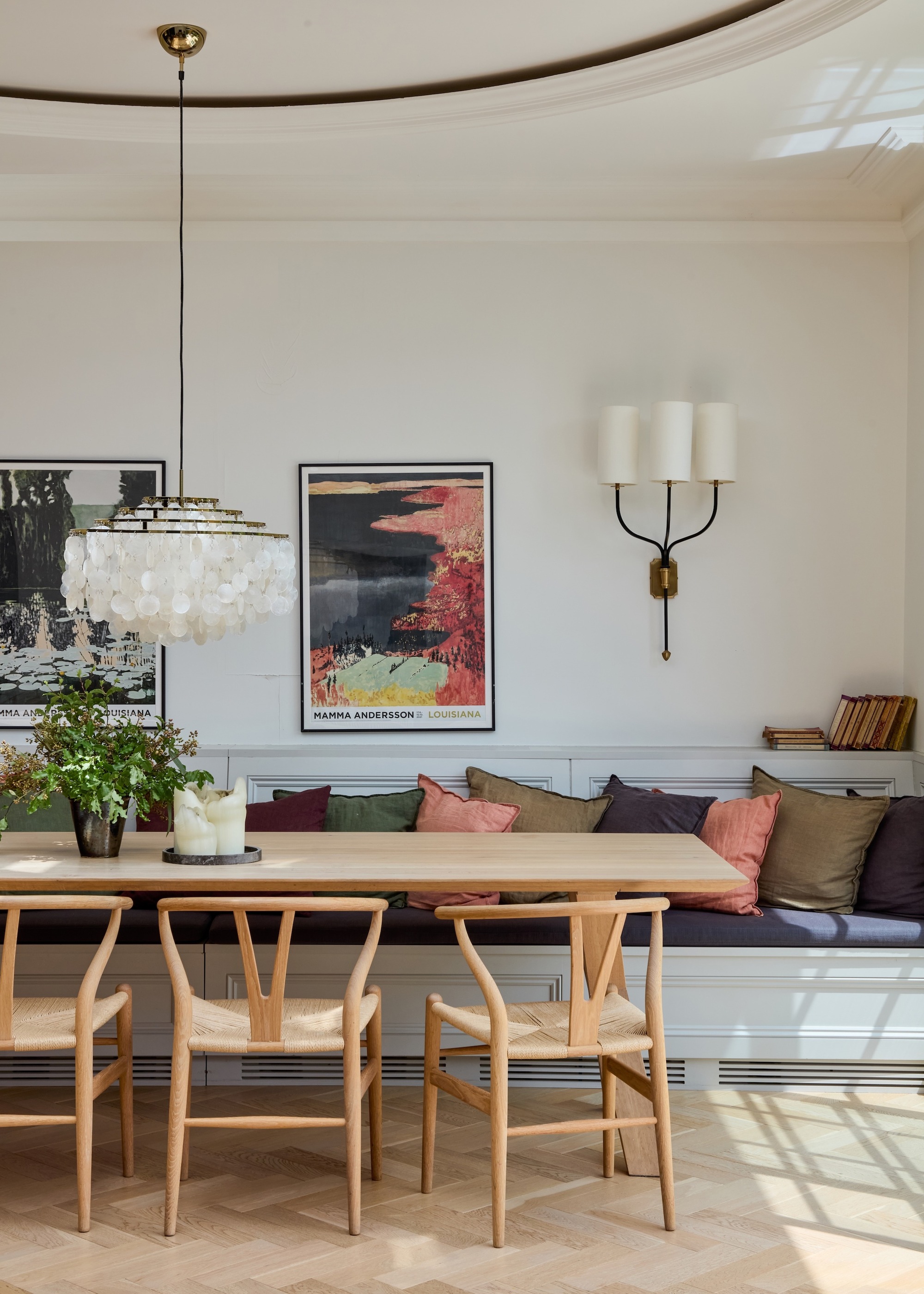 dining area with banquette seating and Carl Hansen chairs