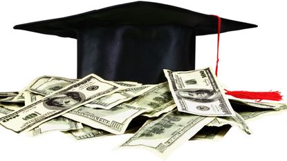 A mortar board is surrounded by hundred-dollar bills.