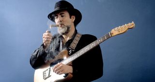 Roy Buchanan lights a cigar 