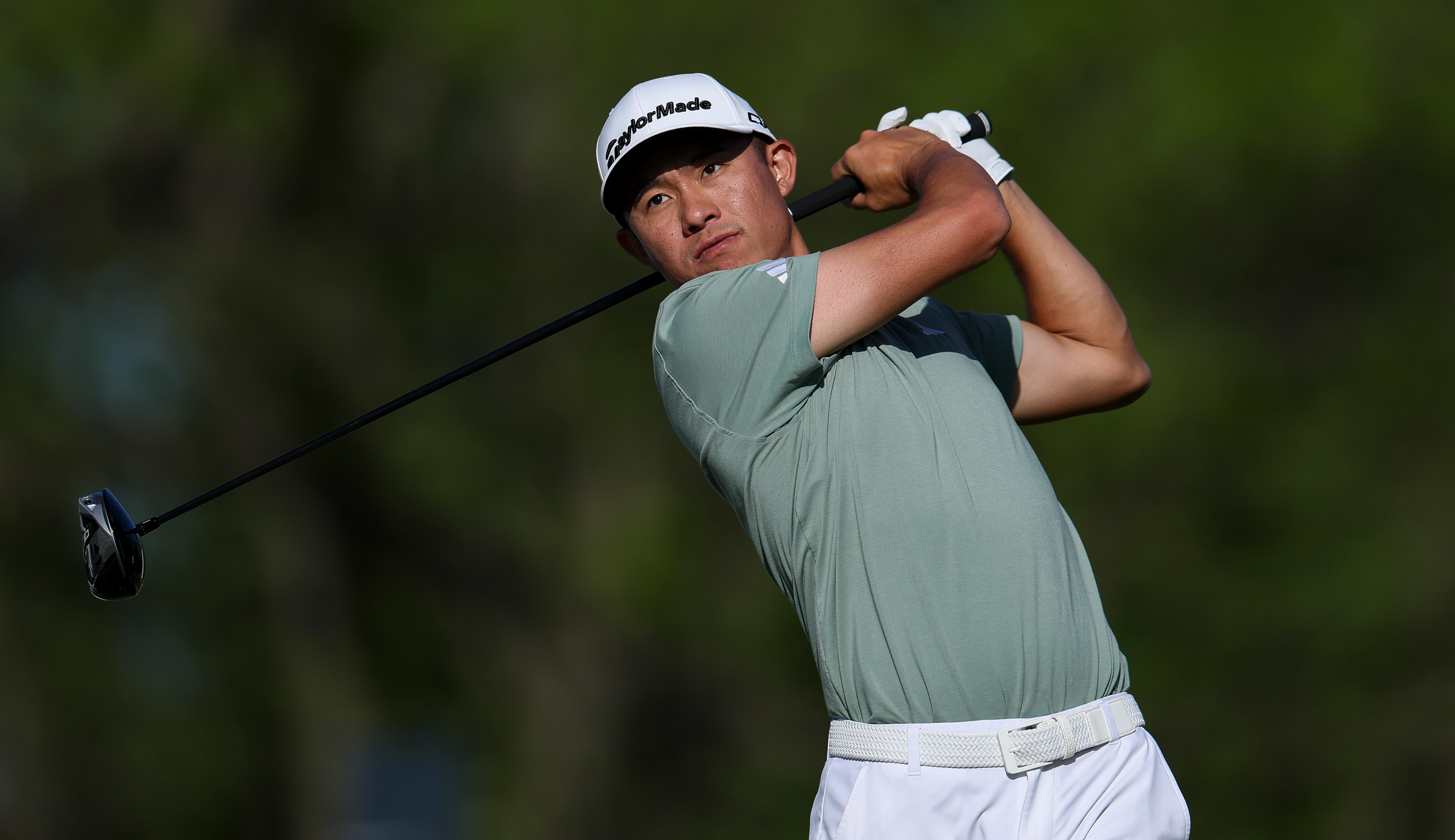 Collin Morikawa hits a tee shot with a driver