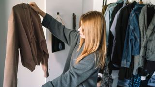 Woman sorting through wardrobe