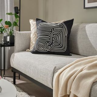 Black cushion with white design