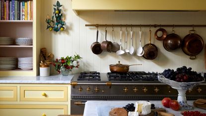 yellow country kitchen with storage rail and oven