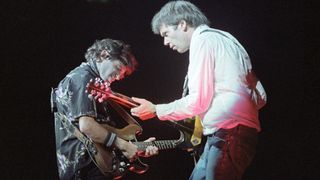 Nils Lofgren and Neil Young perform on stage at Wembley Arena on September 28th, 1982 in London, England