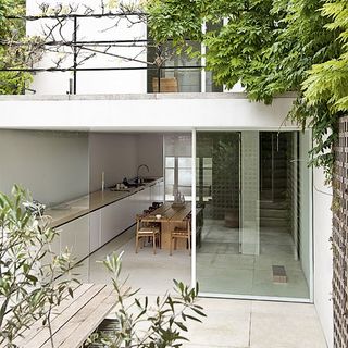 exterior of house with white walls and dinning table with chair