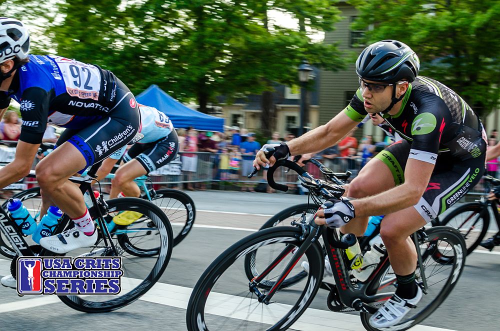 The men race past the crowd out of turn one