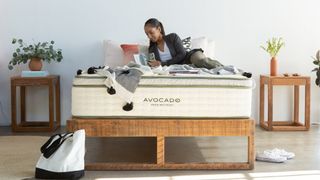 best mattress for side sleepers: A woman with dark hair lies on the Avocado Green Mattress with pillowtop