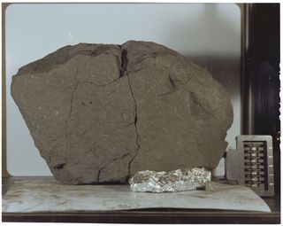 The moon rock known as Lunar Sample 70215 was collected by Apollo 17 astronauts in 1972. The sample weighs 14 grams, and was sliced off a parent rock that originally weighed 8,110 grams.