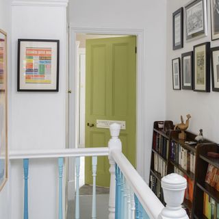 corridor with wooden shelves and painted door