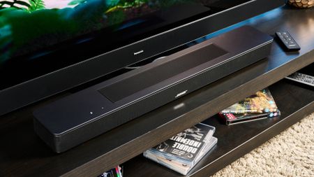 the black bose smart soundbar 2024 with remote, 2 touch controls on top, and mesh covering on top 