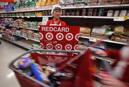 An employee at Target advertises its store credit card.