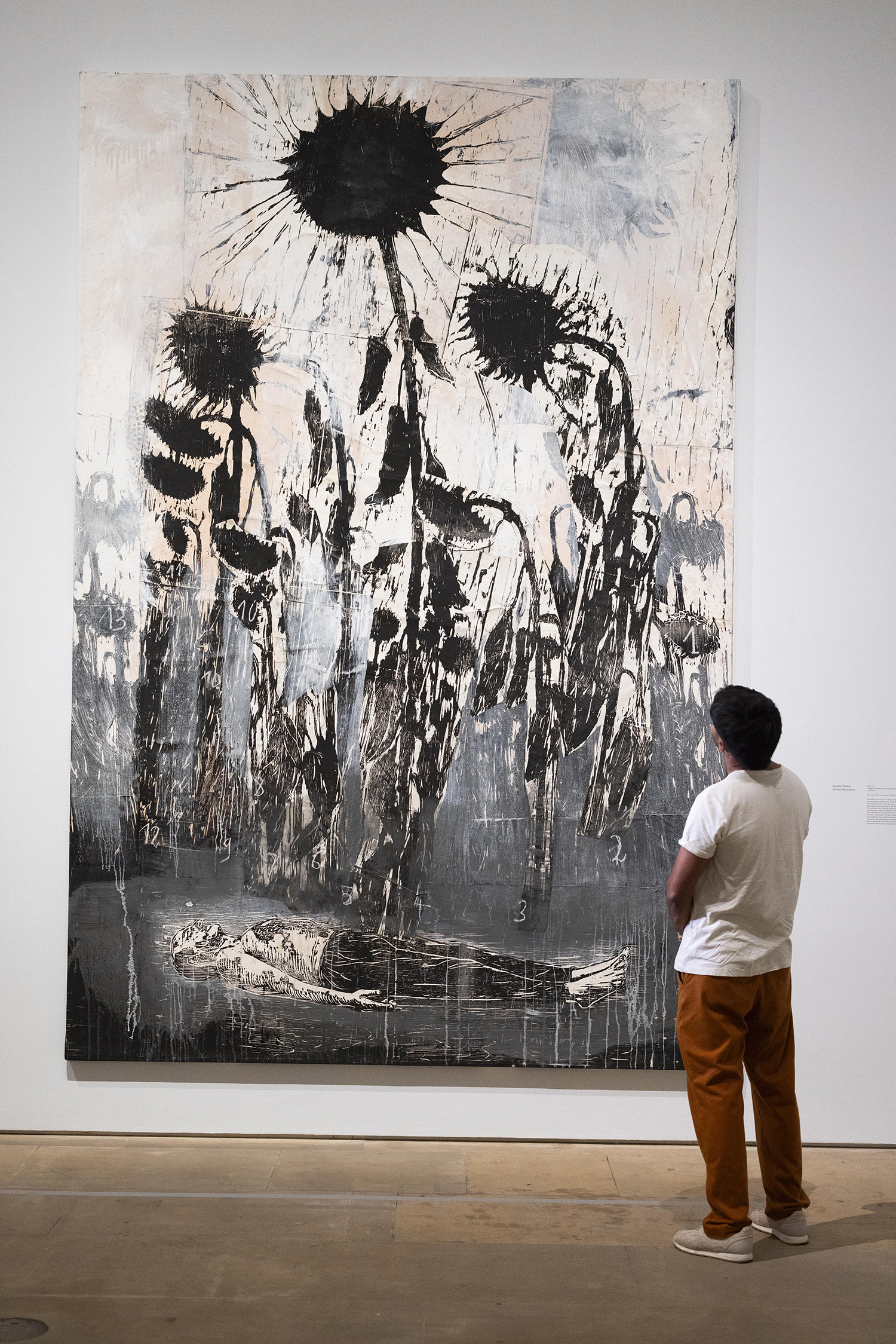 person looking at large textured painting