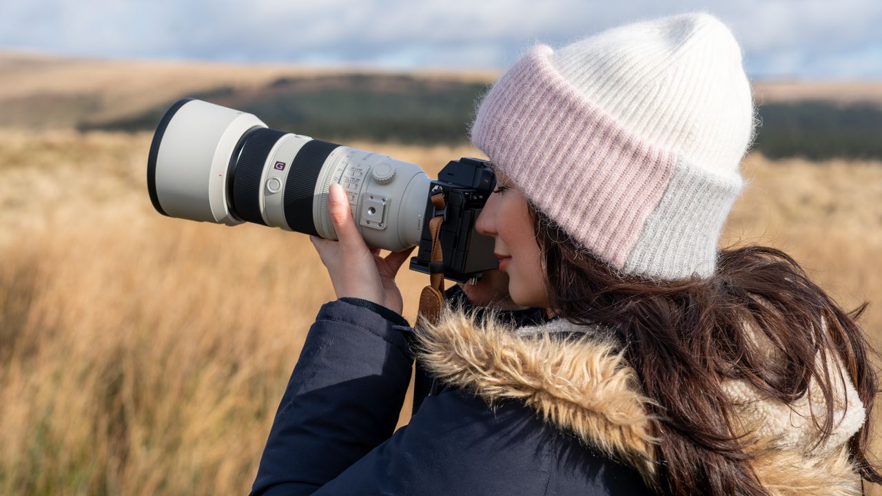 Woman using the Sony A7R V with a telephoto lens