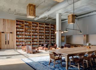 Library furnishings include weathered leather armchairs and custom-made LED reading lights.