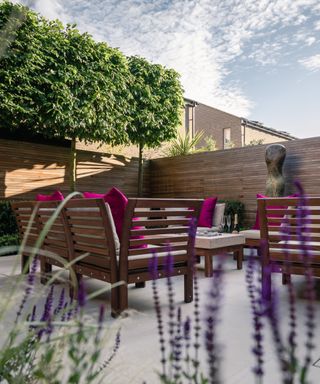 City garden with patio space with furniture, trees and lavender
